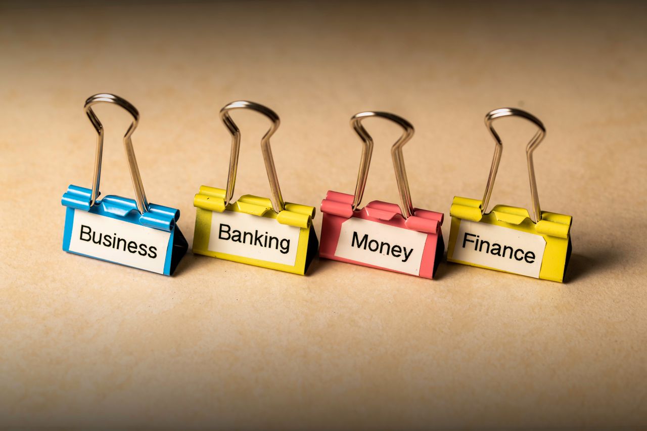 Crafting Captivating Headlines: Your awesome post title goes here Close-up of binder clips with labels for business, banking, money, and finance concepts.